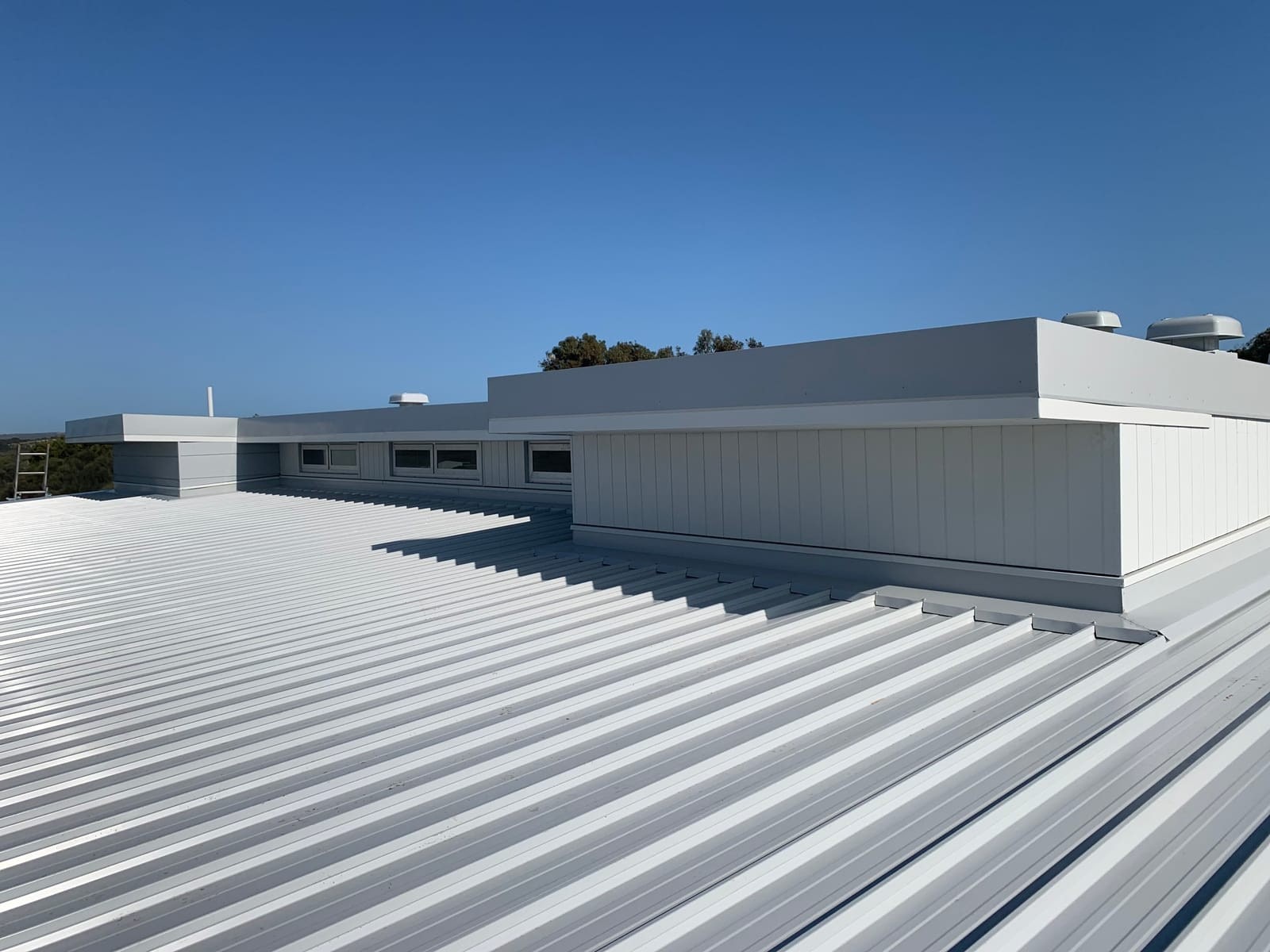 A freshly finished flat metal roof on a modern home.