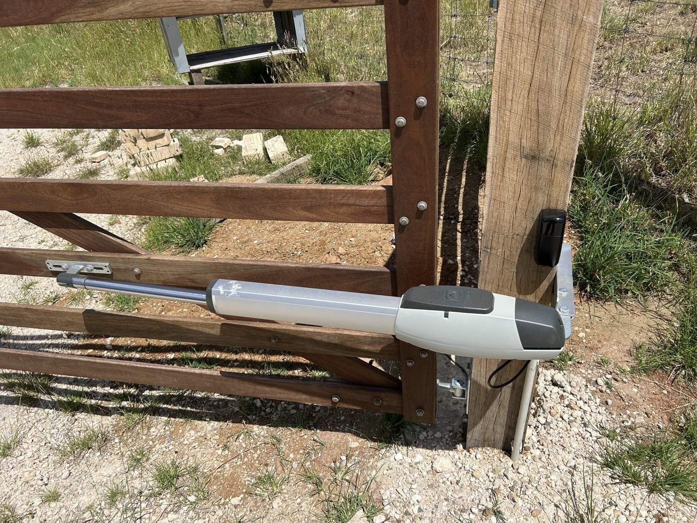 A gate motor arm fitted to a timber gate.