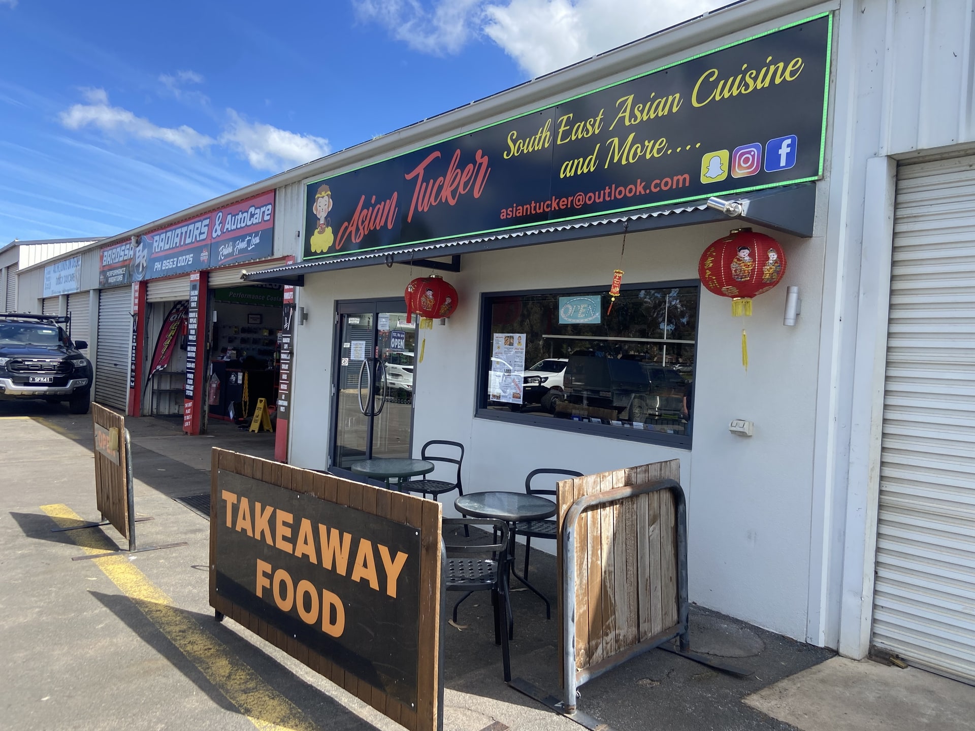 The Asian Tucker shopfront with a takeaway food A-frame.
