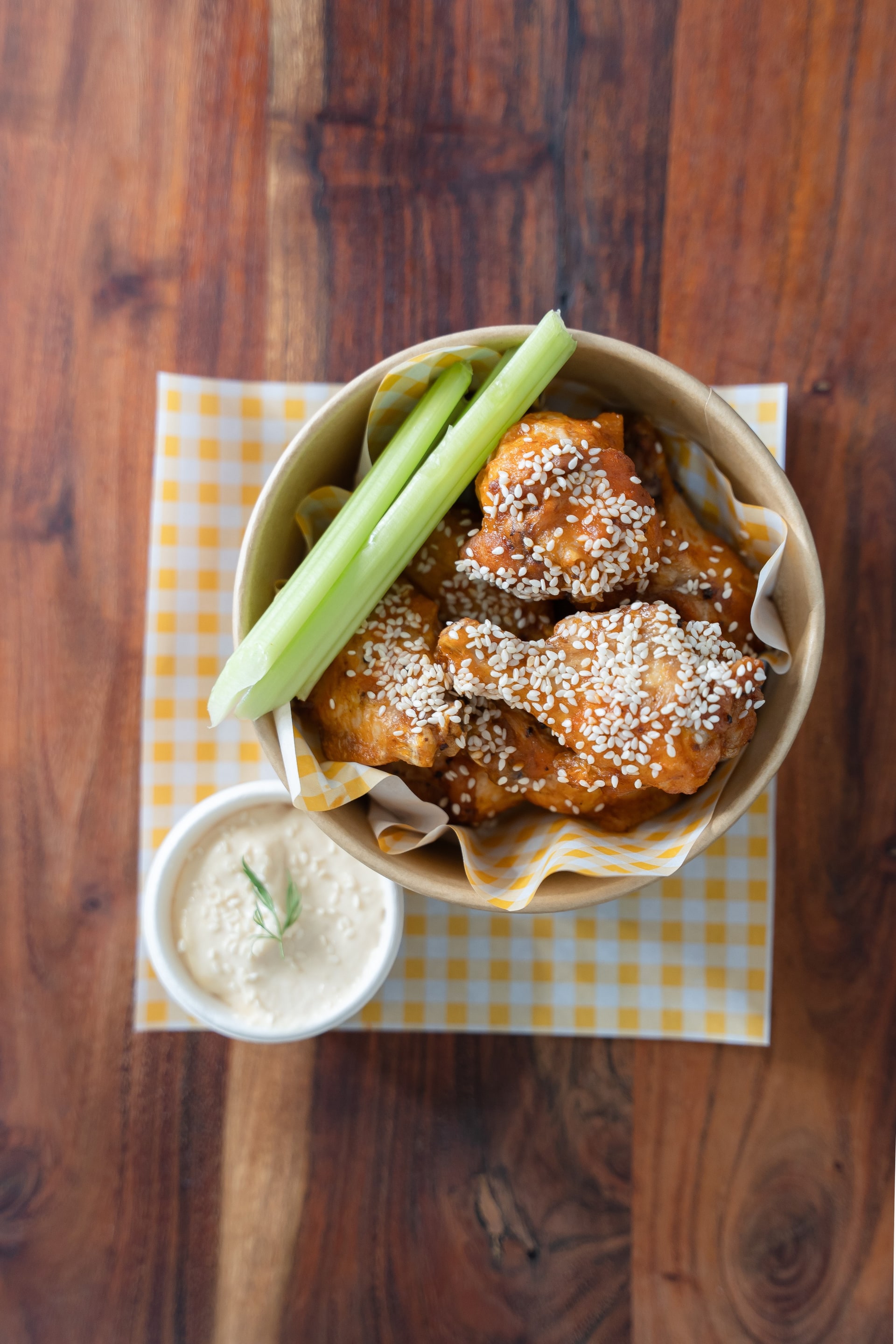 Crispy buffalo wings with sesame, celery and a dipping sauce, from Auggie’s Kitchen.