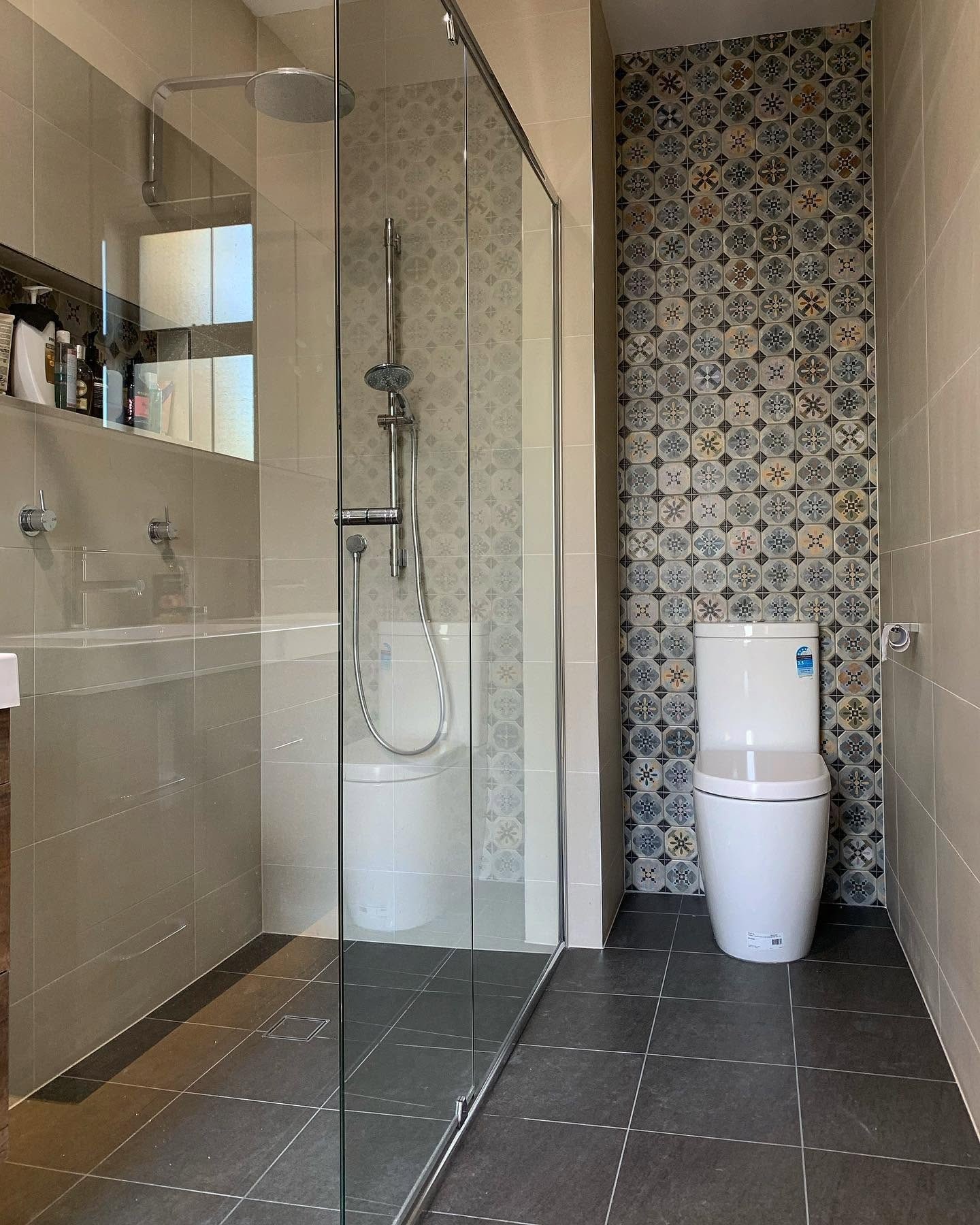 A patterned feature wall in a shower tiled by Becks.