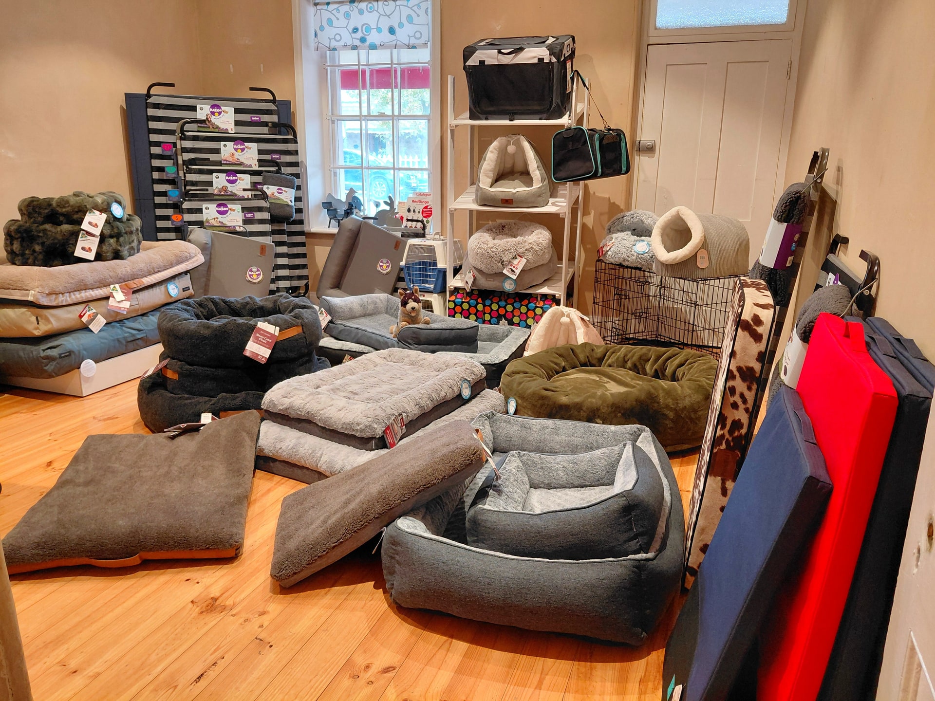 Dog beds, mats, carriers and cat caves on display inside For Pets Sake in Angaston.