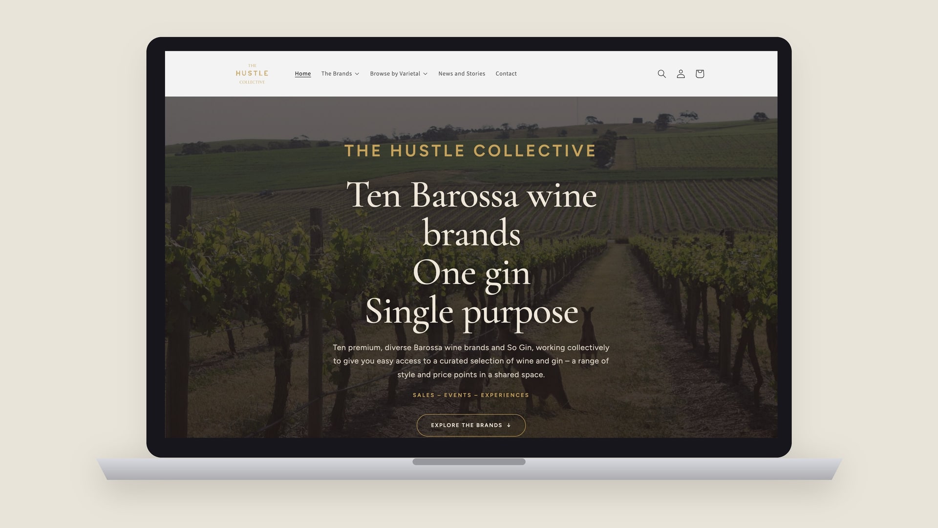 The Hustle Collective Shopify homepage on a laptop: ten Barossa wine brands, one gin, single purpose.