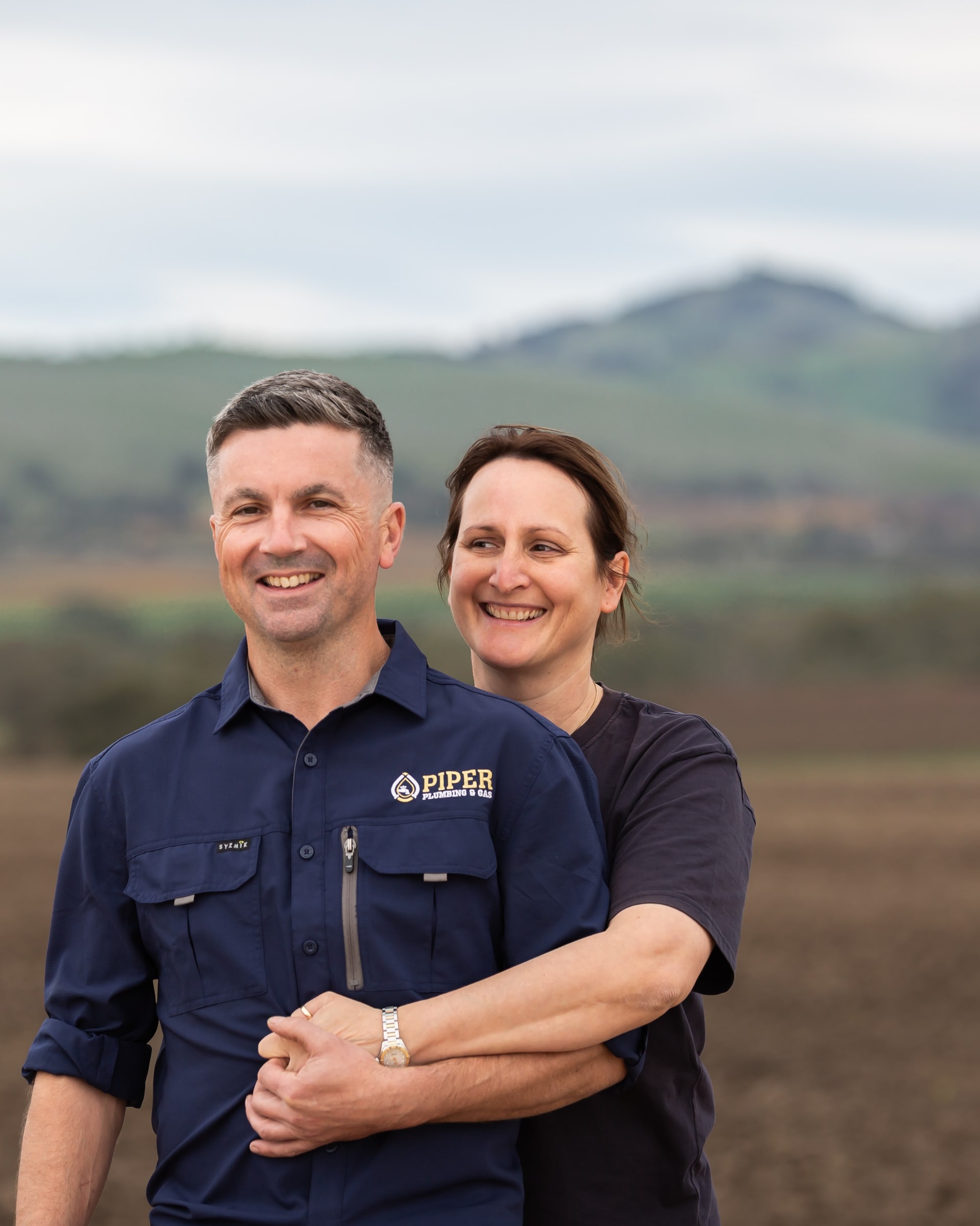 Craig and Hayley of Piper Plumbing & Gas, standing in a Barossa paddock.