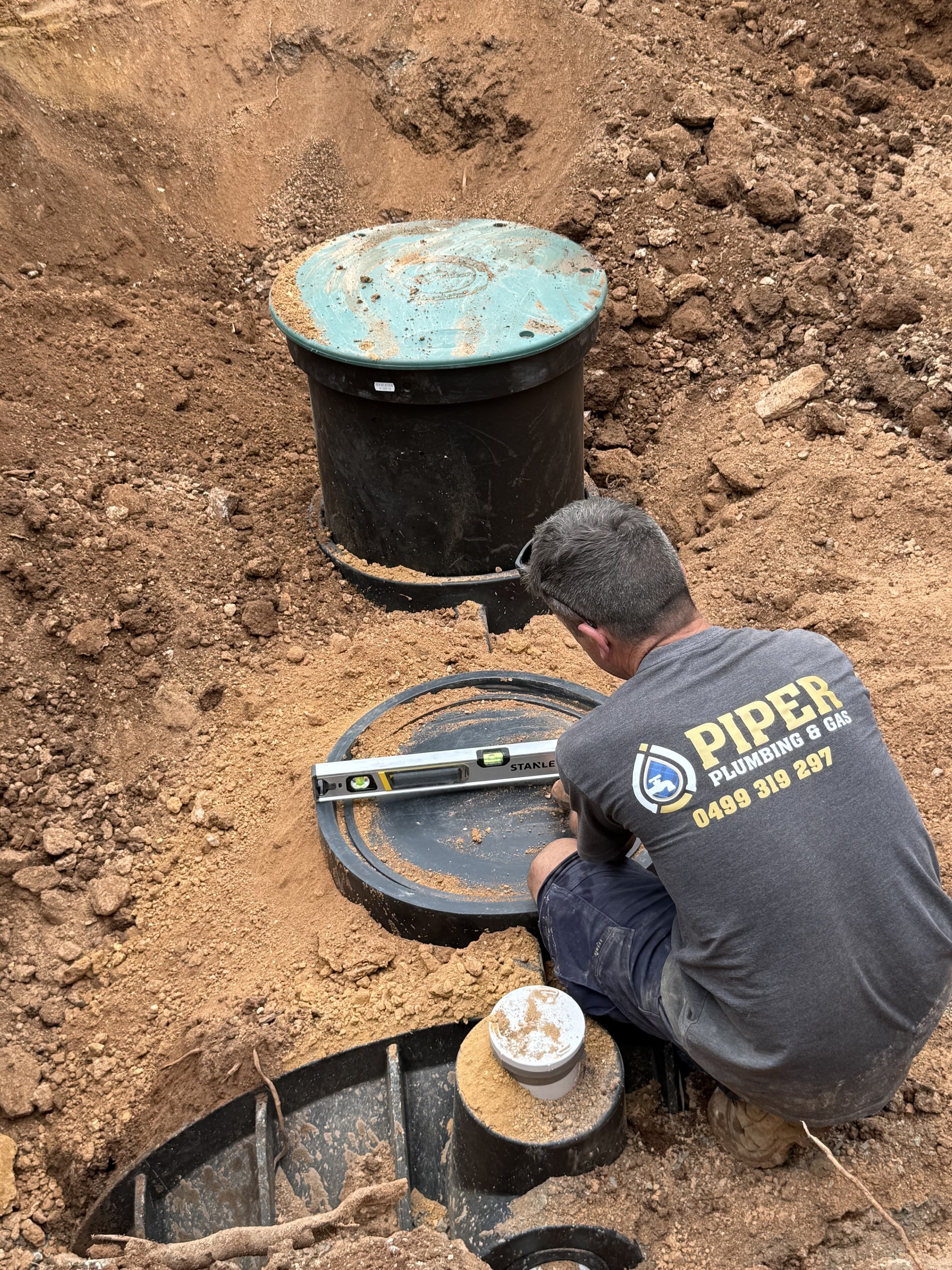 A septic tank being installed in an excavation.