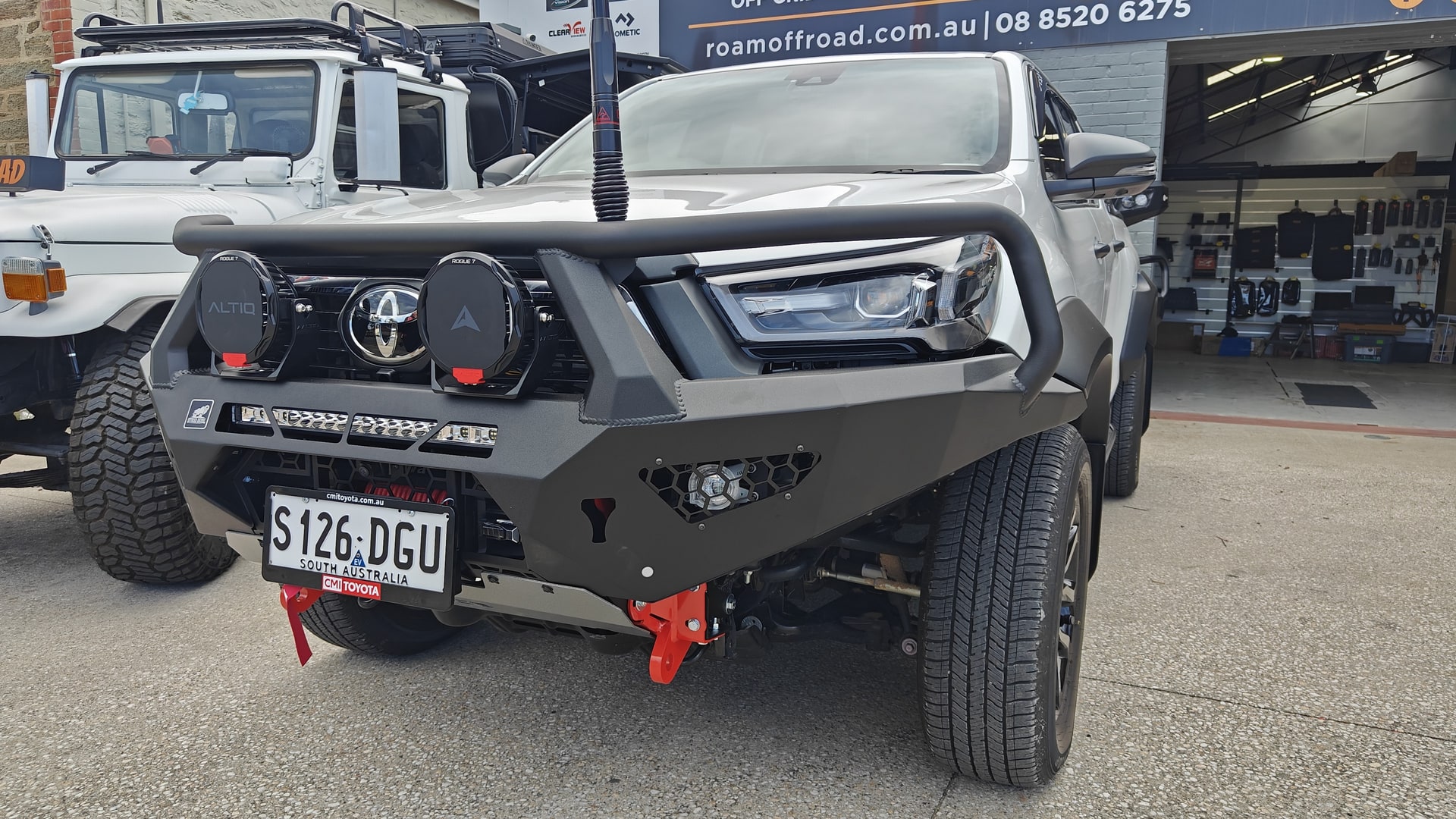 A Toyota HiLux fitted with an Offroad Animal bull bar and driving lights outside the Roam Offroad shop in Gawler South.