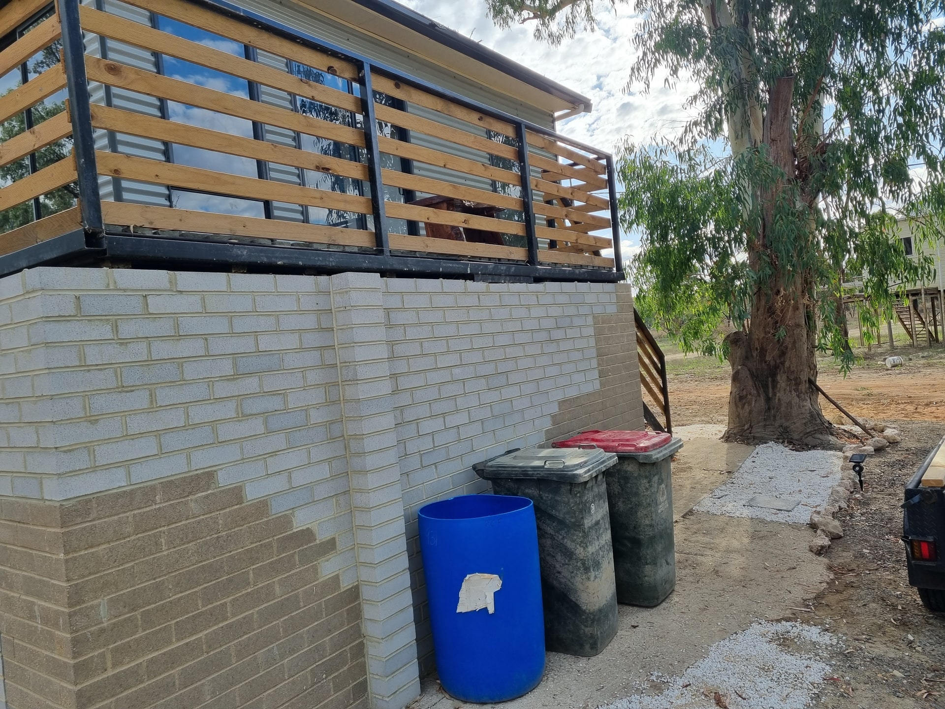 A new deck balustrade over a brick base.