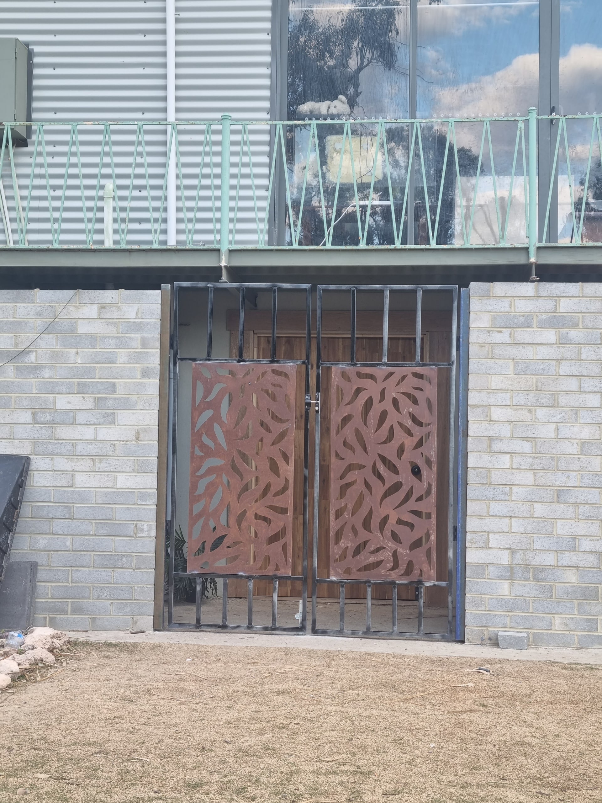 Laser-cut screen gates under a deck.
