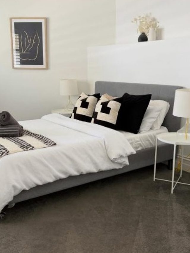 A bedroom left guest-ready by Barossa Valley Cleaning Services: fresh white linen, cushions and rolled towels on the bed.